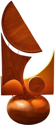Balance: an abstract wood sculpture with a sail-like curved panel and a glowing light behind its cutout forms, on a rounded wooden base